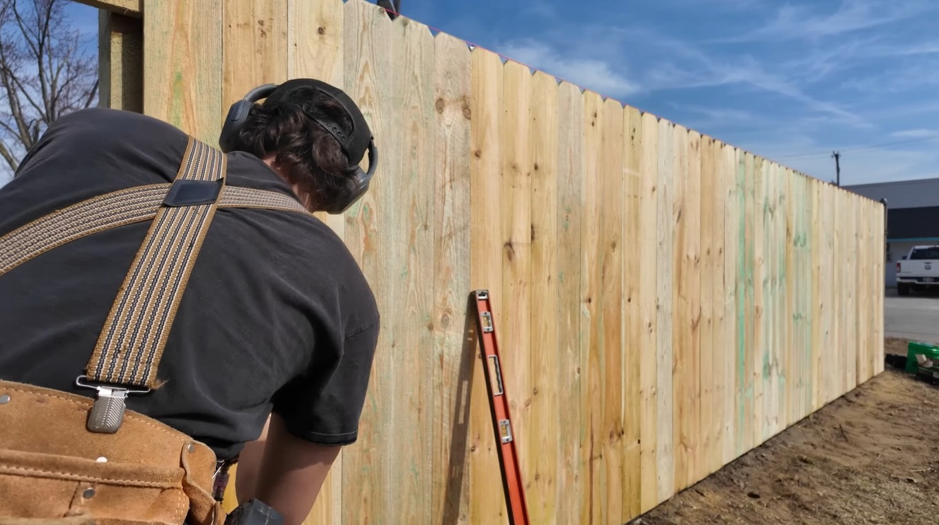 Professional fence contractor installing wooden fence in Perth Amboy, NJ